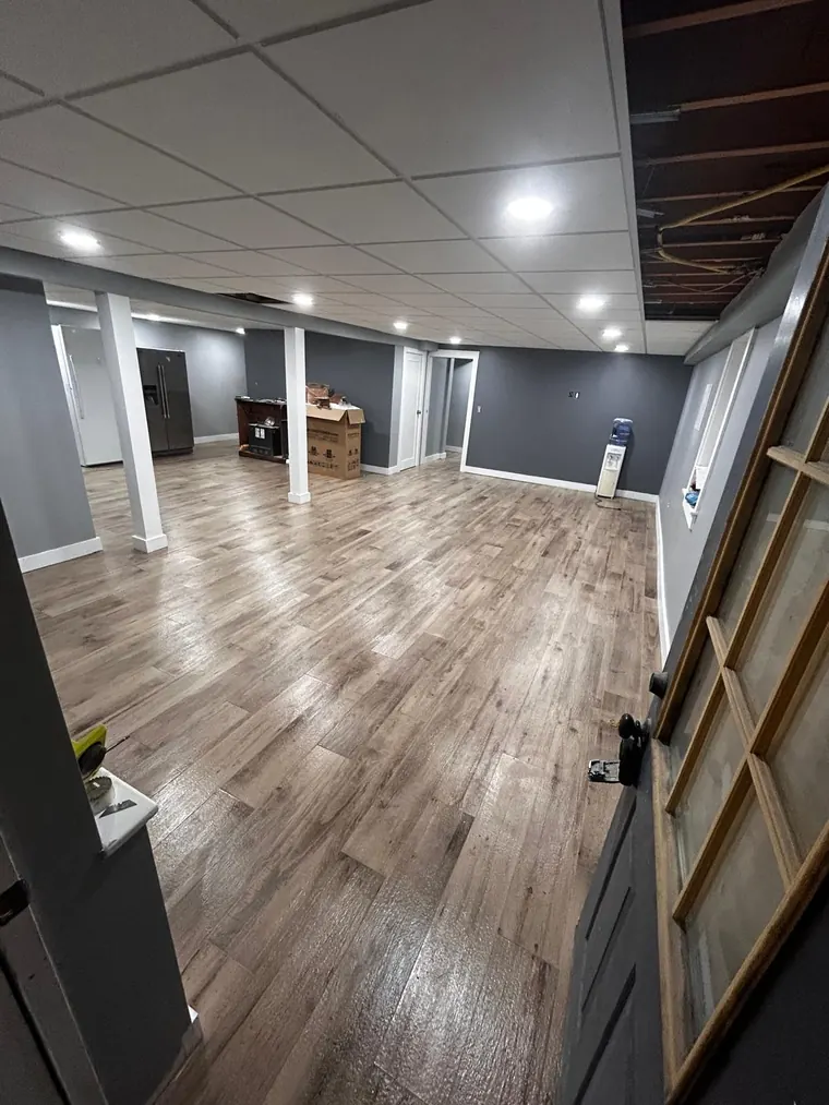 Wood look plank flooring installed across a finished basement