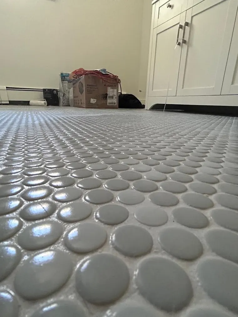 Penny round mosaic floor tile installed edge to edge
