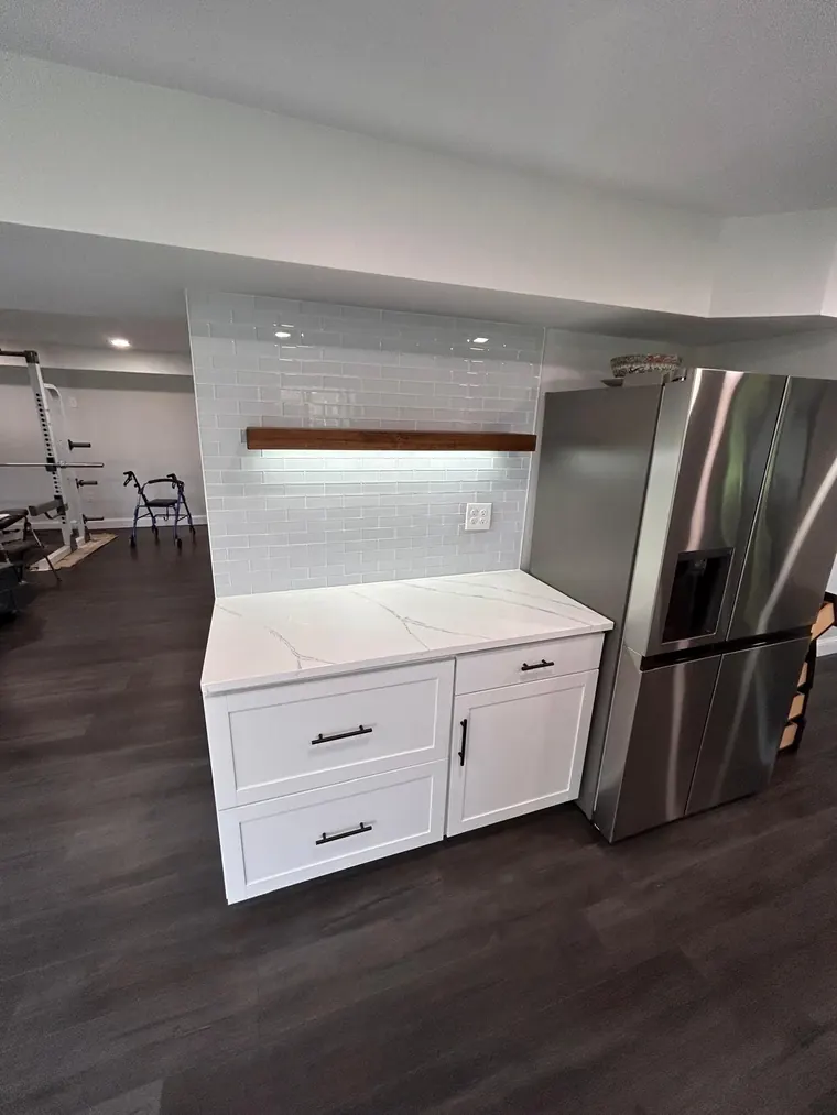 Kitchen island and cabinets installed on a wood look plank floor